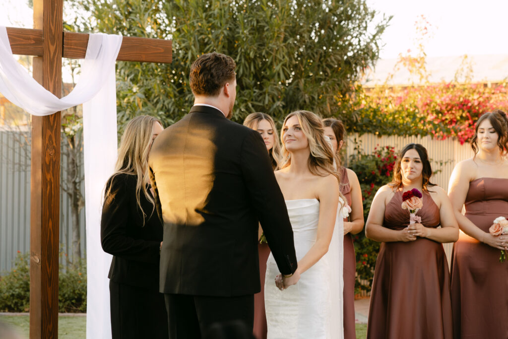 Outdoor wedding ceremony at Schnepf Farms Big Red Barn in Queen Creek Arizona during sunset