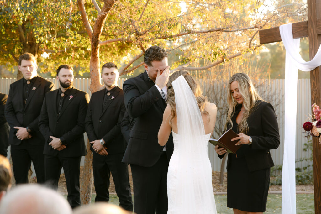 Outdoor wedding ceremony at Schnepf Farms Big Red Barn in Queen Creek Arizona during sunset
