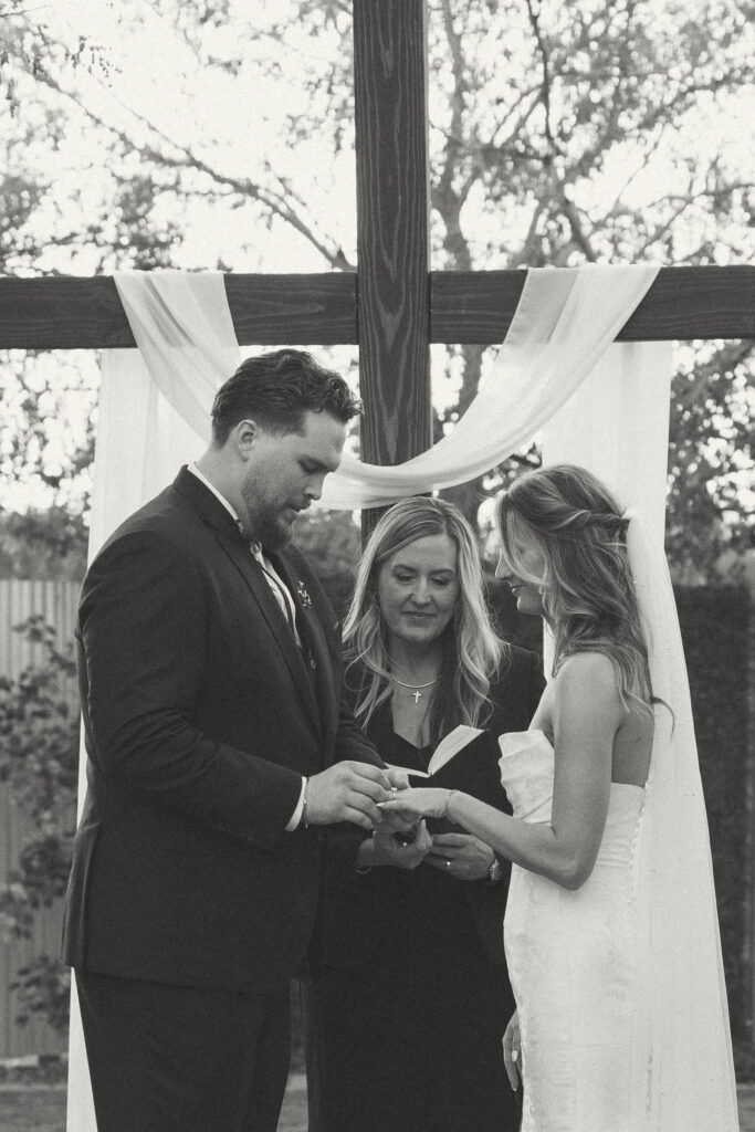 Outdoor wedding ceremony at Schnepf Farms Big Red Barn in Queen Creek Arizona during sunset