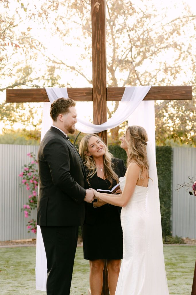 Outdoor wedding ceremony at Schnepf Farms Big Red Barn in Queen Creek Arizona during sunset