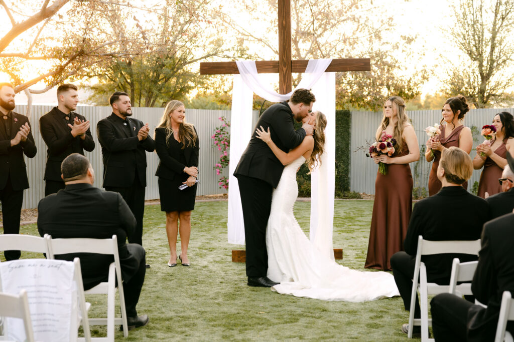 Outdoor wedding ceremony at Schnepf Farms Big Red Barn in Queen Creek Arizona during sunset
