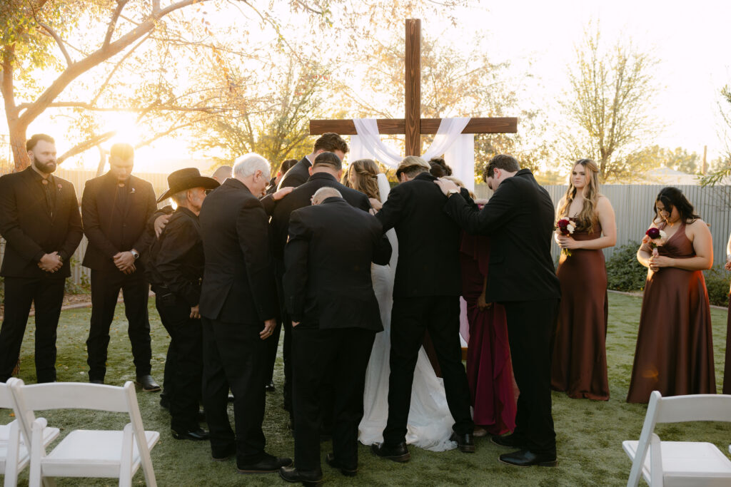 Outdoor wedding ceremony at Schnepf Farms Big Red Barn in Queen Creek Arizona during sunset