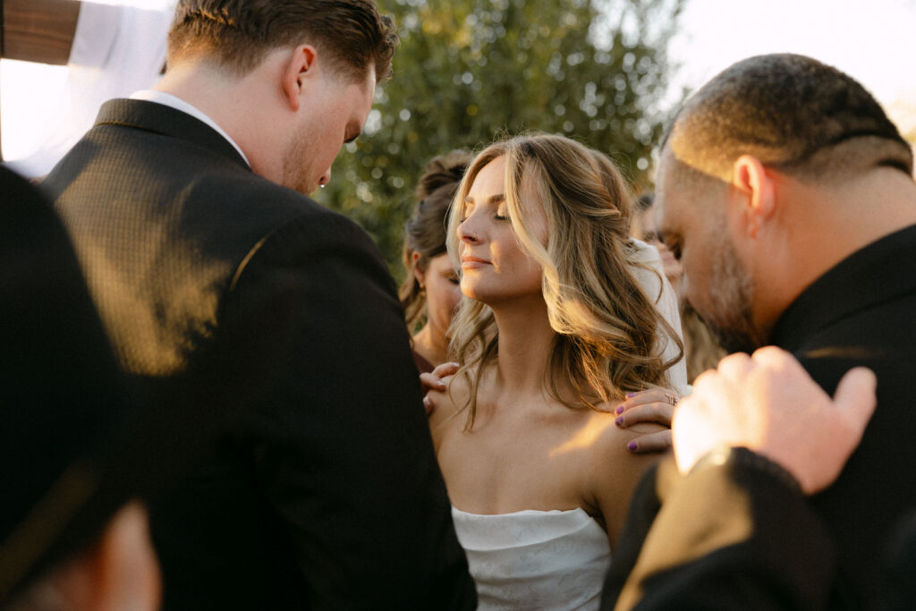 Emotional prayer during wedding ceremony at Schnepf Farms wedding venue in Arizona