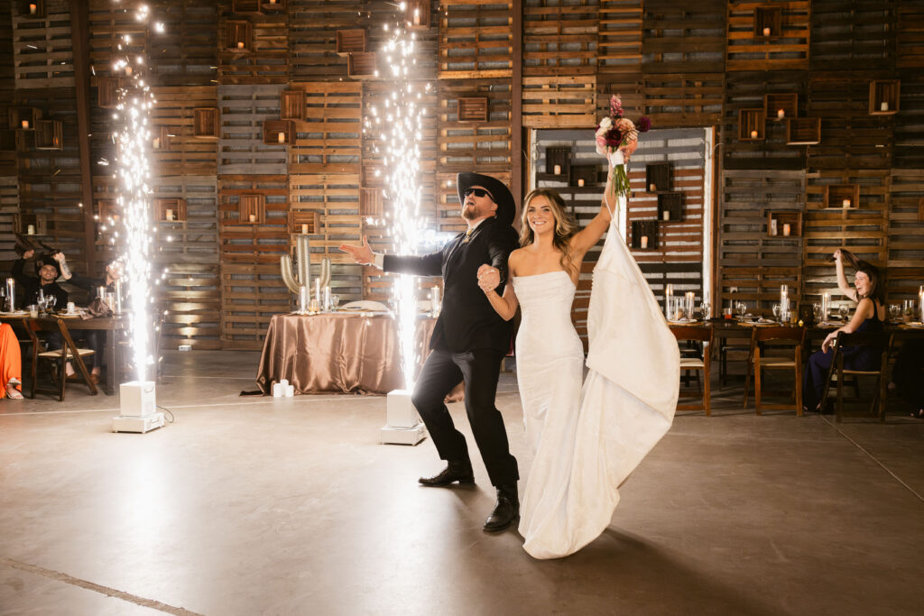 Bride and groom reception entrance with indoor sparklers at Big Red Barn wedding reception