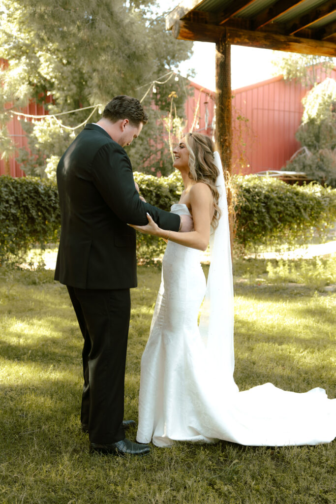 Bride and groom sharing private vows during first look at Schnepf Farms Big Red Barn in Queen Creek Arizona