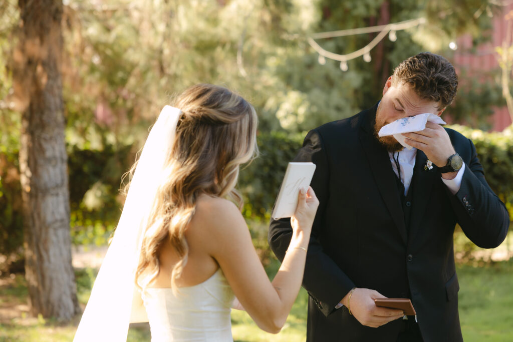Bride and groom sharing private vows during first look at Schnepf Farms Big Red Barn in Queen Creek Arizona