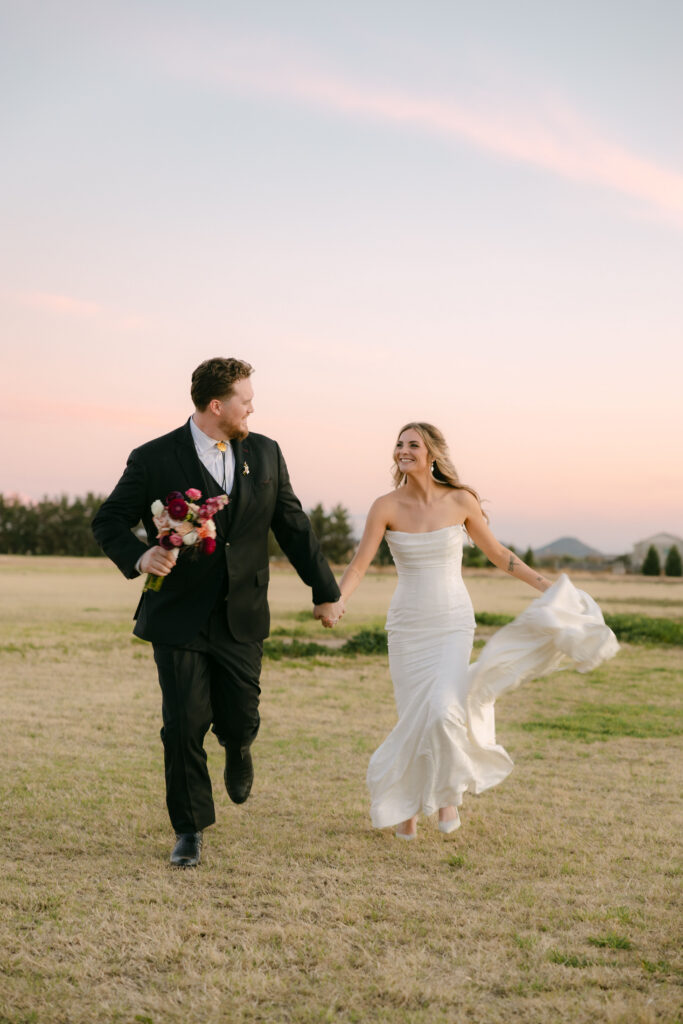 bride and groom running wedding portraits at Schnepf Farms Big Red Barn in Arizona