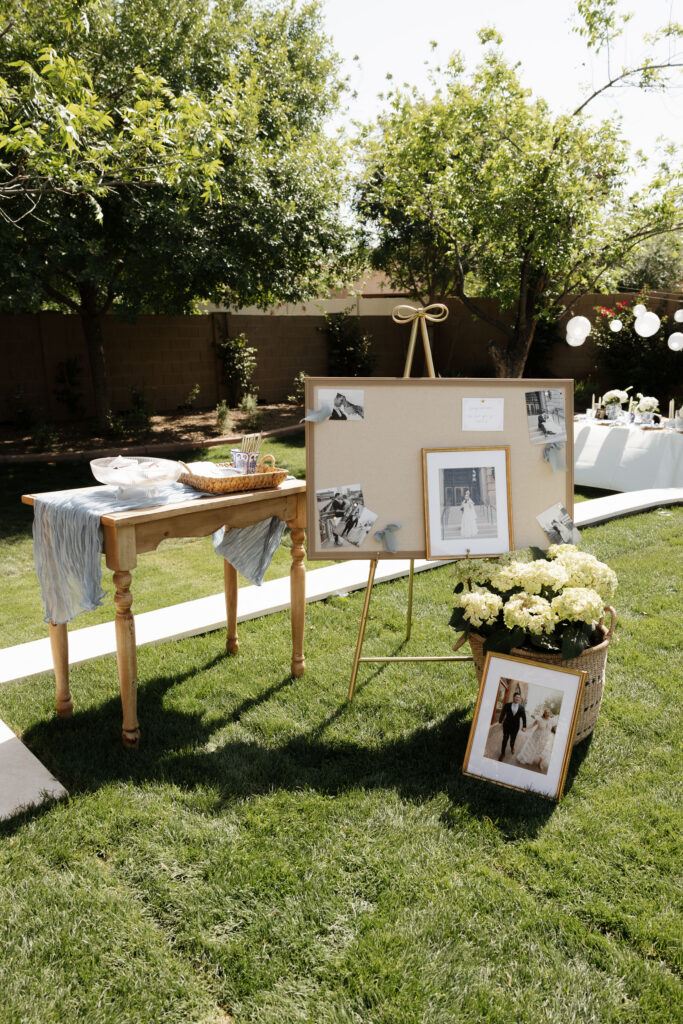 Elegant backyard wedding reception table with white lanterns and blue details. Garden themed backyard wedding.